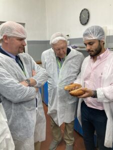 USW Regional Vice President Ian Flagg, left, and Mark Spurgin, of the Nebraska Wheat Board (center) inspect products during a tour of the Al Assyl flour Mill in Egypt.