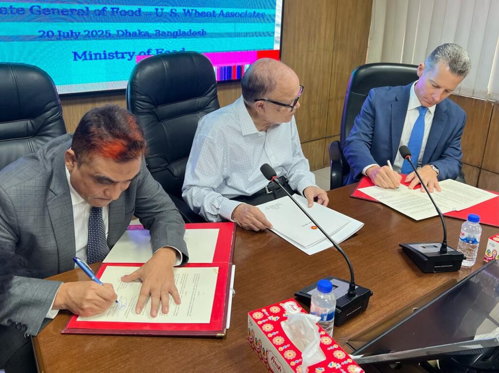three men sign papers