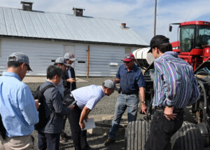 Japanese trade team asks questions about farm equipment.