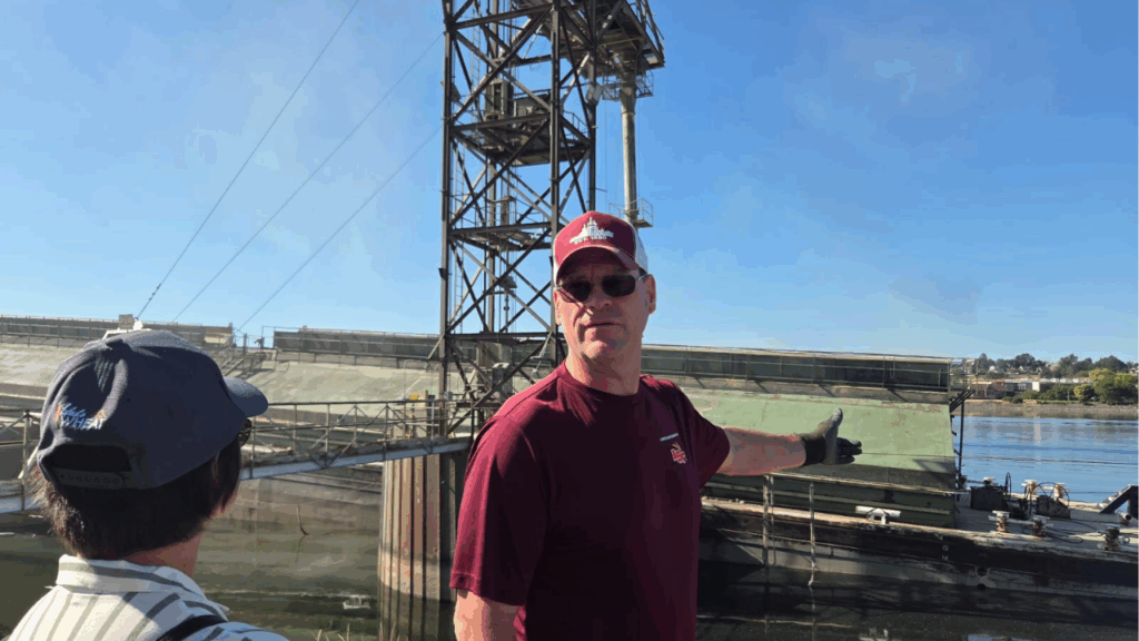 The team watched wheat being loaded onto a barge.