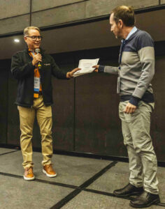 USW Director of Technical Services Marcelo Mitre, right, is given a certificate of appreciation by a representative of the International Association of the Operative Millers (IAOM) Latin America after his presentation on U.S. wheat.
