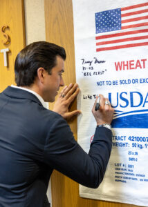 Lindberg signing a food aid bag