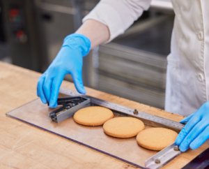 USW photo of technician conducting a cookie spread test for soft wheat.