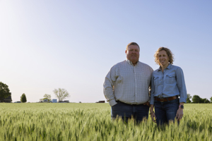 Derek and Katie Sawyer stand in one of the family's wheat fields in McPherson, Kansas.